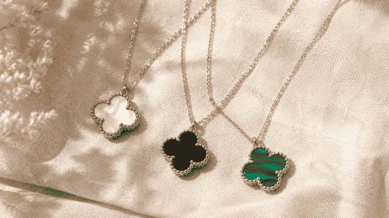 Van Cleef Alhambra inspired clover necklace dupes in mother-of-pearl, onyx and malachite flat lay