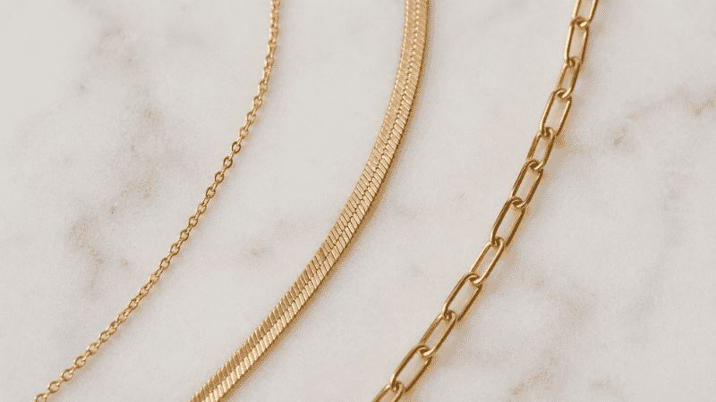 different necklace chain textures for layering — cable chain, herringbone chain, and paperclip chain