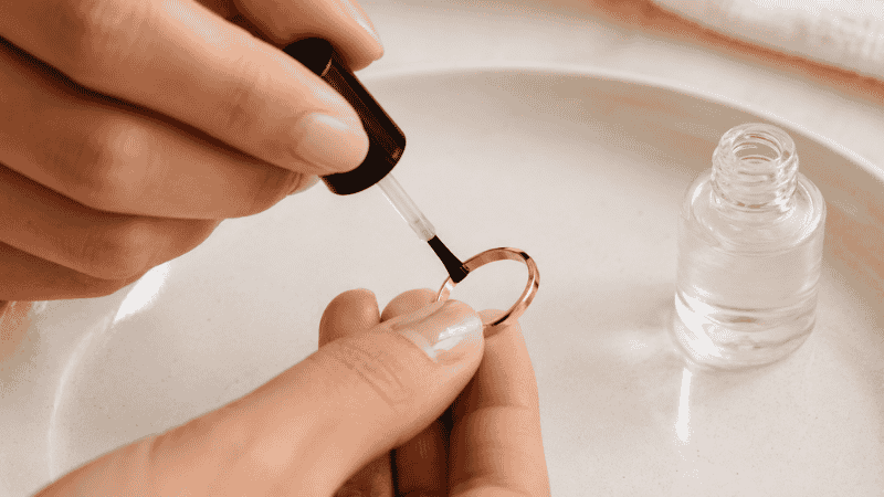 applying clear nail polish to inside of gold ring band to prevent tarnishing and skin contact
