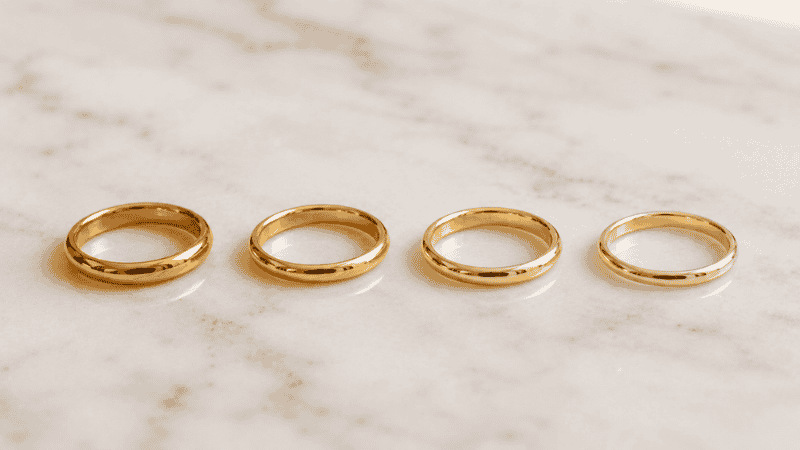 gold karat comparison — four rings showing color difference between 10k 14k 18k gold tones