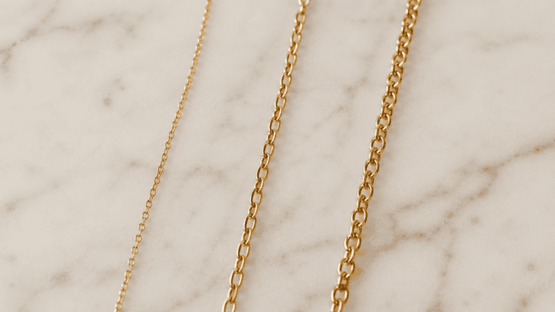 gold plated vs gold vermeil vs gold filled necklace chains comparison — three chains showing material and tone differences