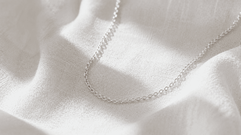 sterling silver 925 necklace — cool bright silver tone delicate chain on white linen surface
