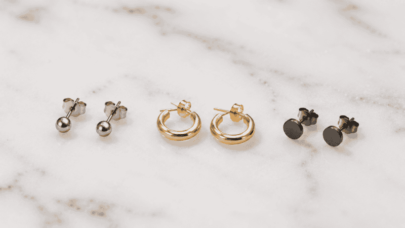 hypoallergenic earrings for sensitive ears — titanium studs solid gold hoops and niobium studs showing safe earring material options